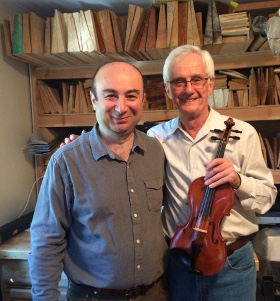 Oleh Krysa with Andranik's violin in Andranik's shop